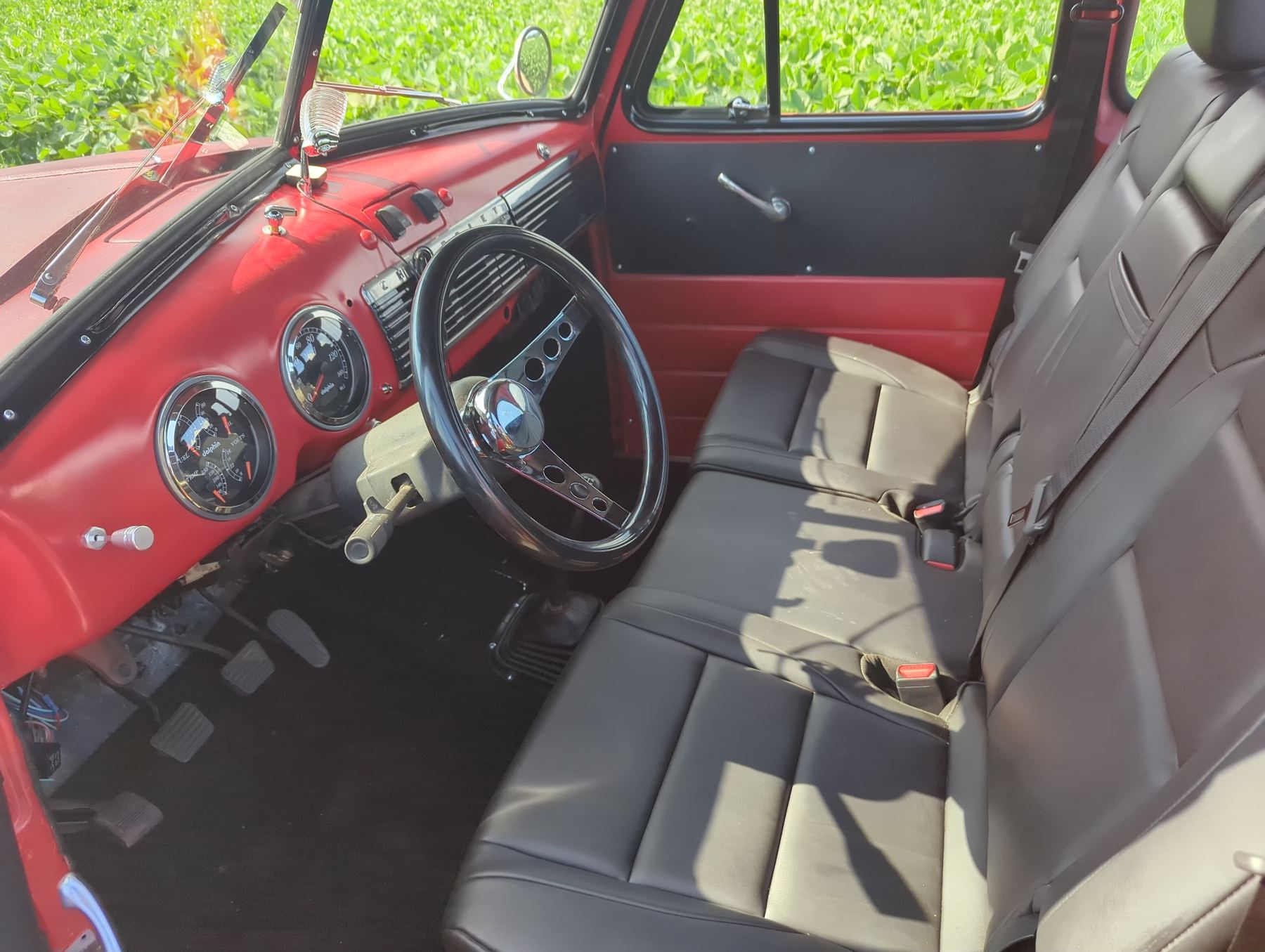 Red dashboard and gray bench seat
